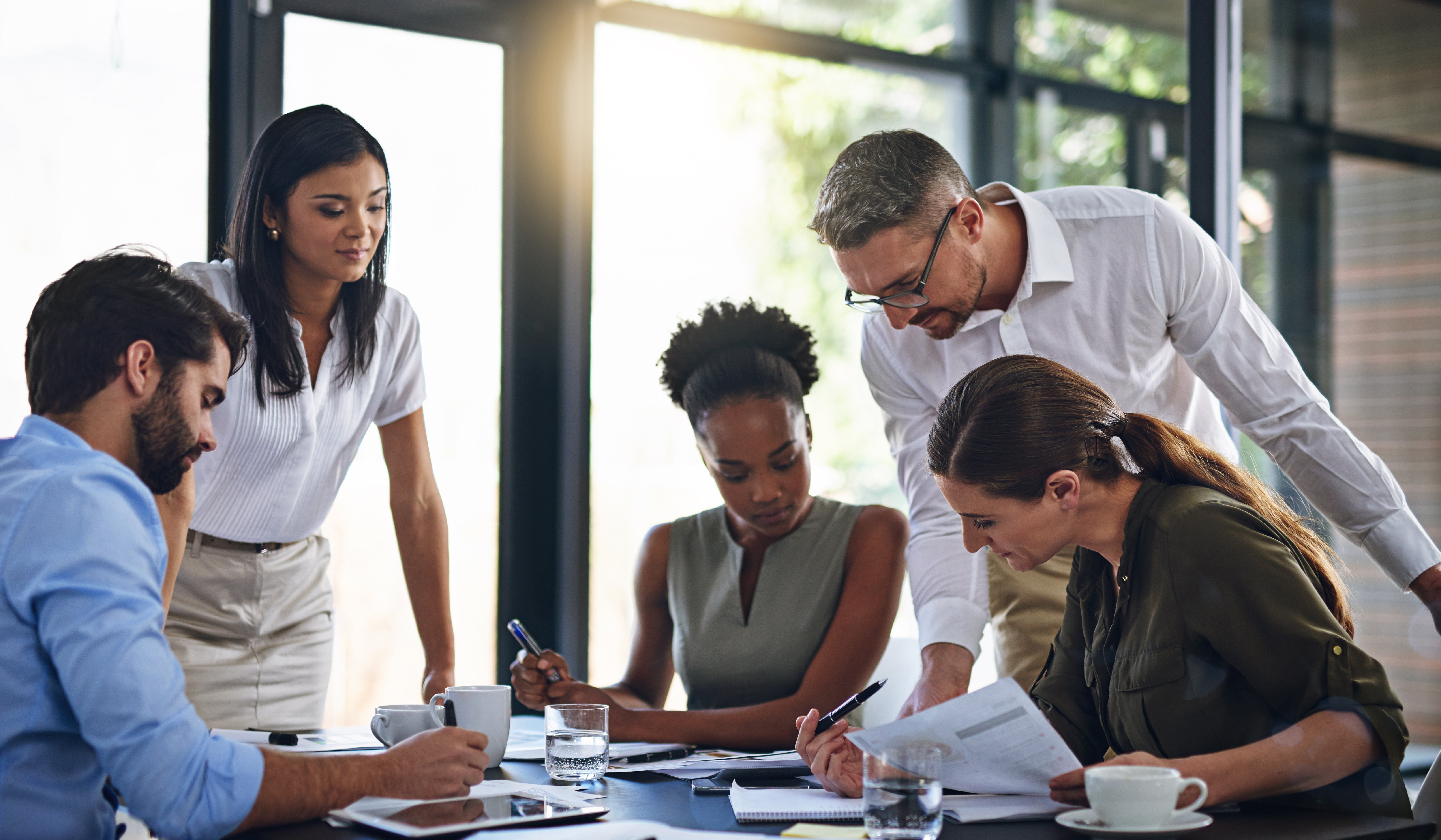 Business people gathered around a table planning